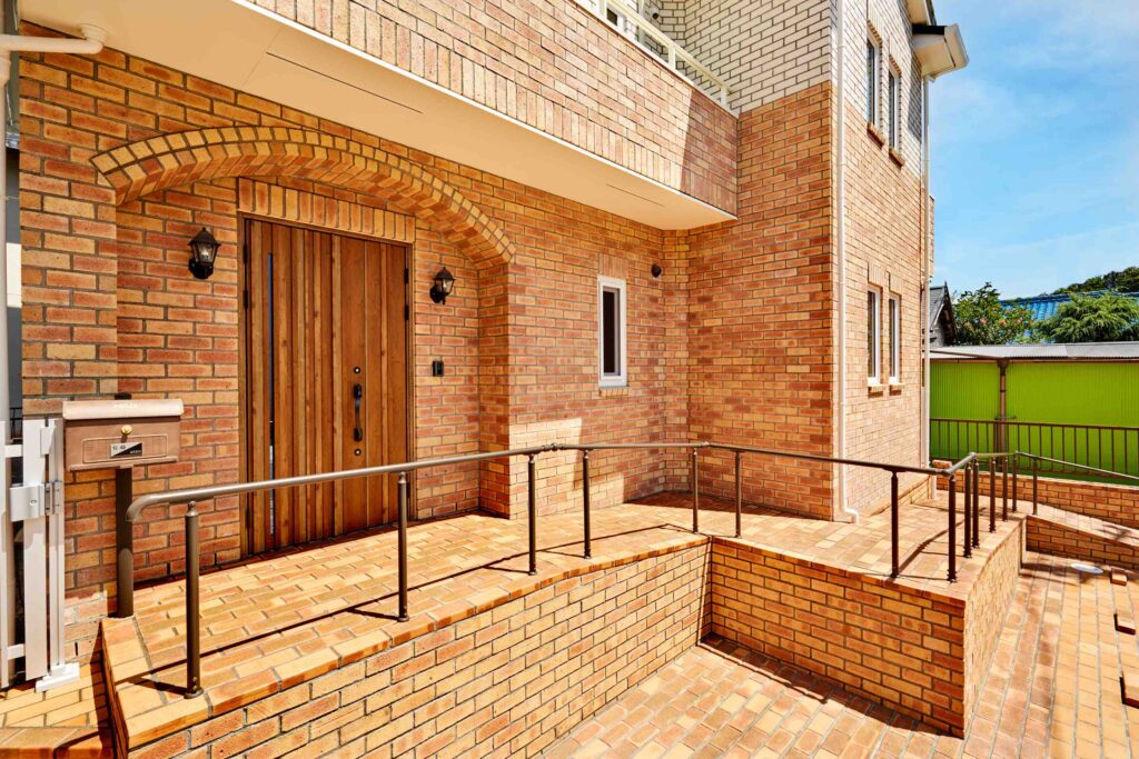 素材から考えた健康を育むレンガ積みの家のやわらかなアーチが印象的な玄関まわりの写真