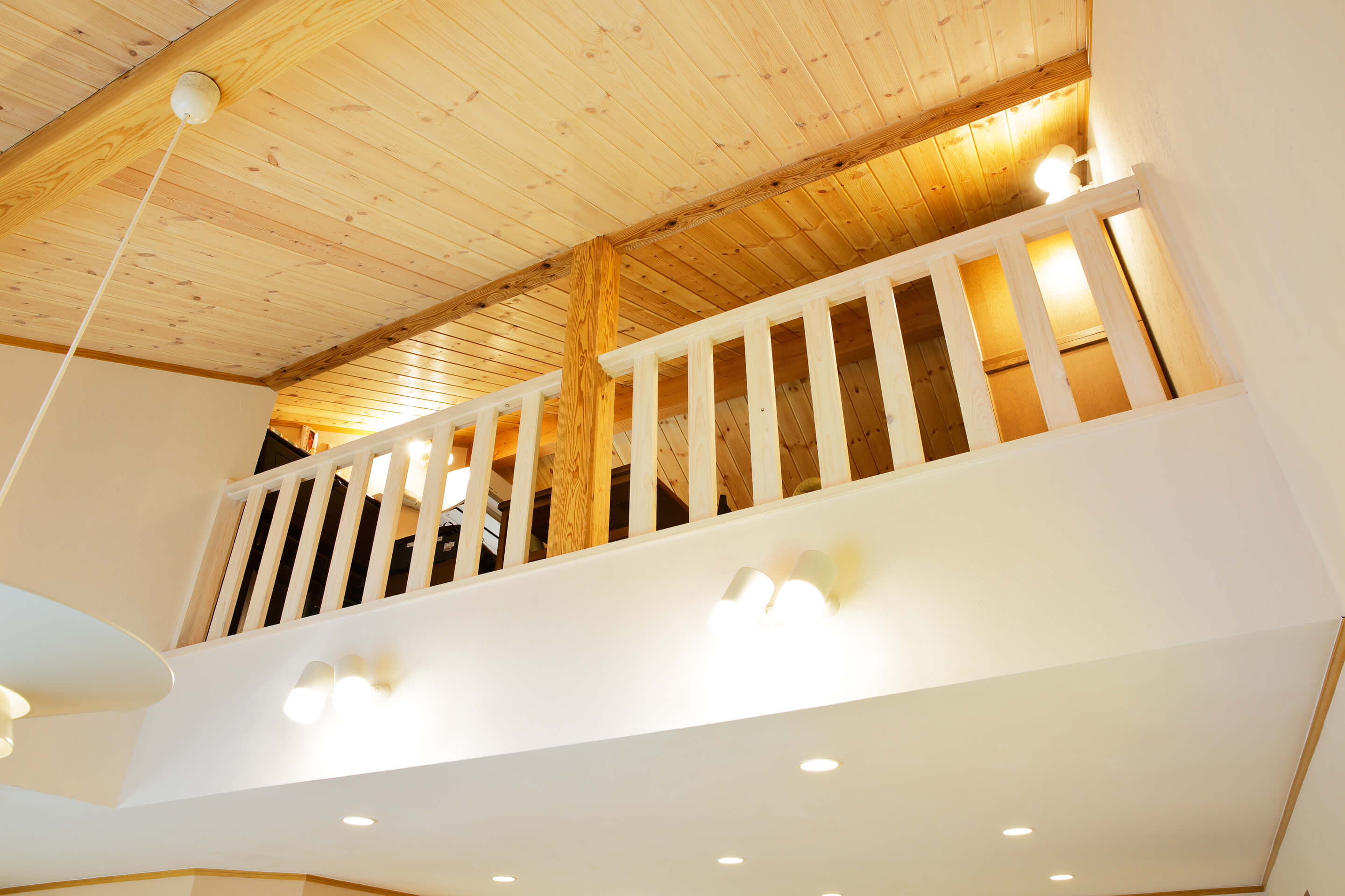 素材から考えた健康を育むレンガ積みの家の吹き抜けからつながる屋根裏部屋の写真